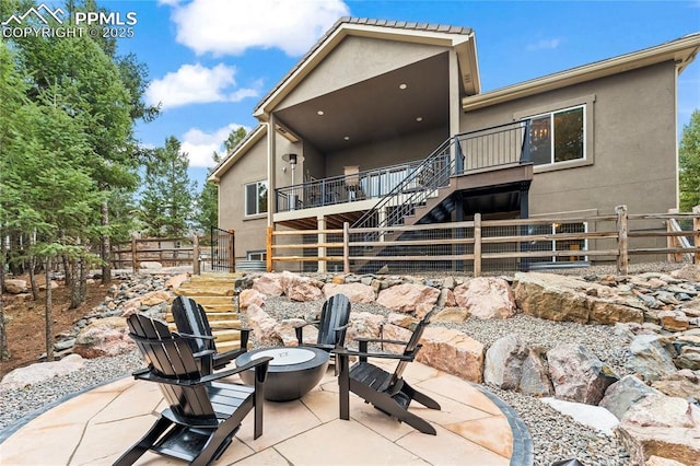 view of patio with a fire pit and stairs