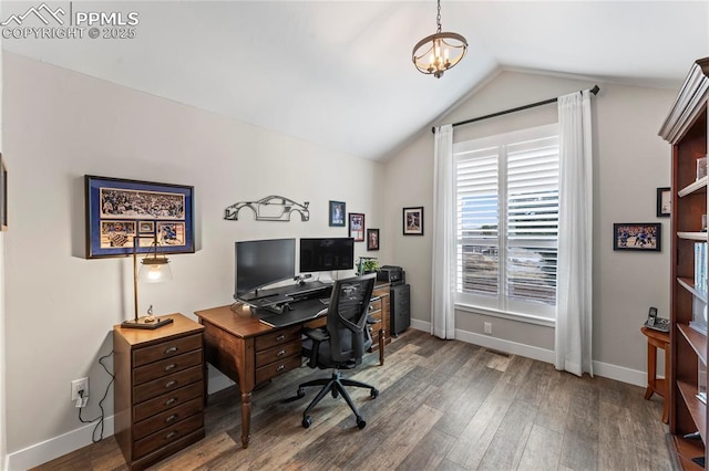 office with vaulted ceiling, an inviting chandelier, wood finished floors, and baseboards