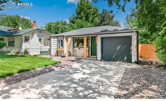 ranch-style home with concrete driveway, covered porch, fence, a garage, and a front lawn