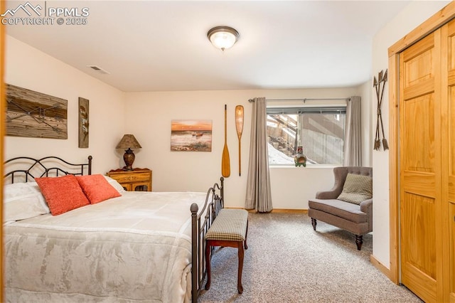 bedroom with carpet floors, visible vents, and baseboards