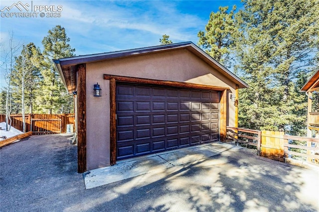 detached garage featuring fence