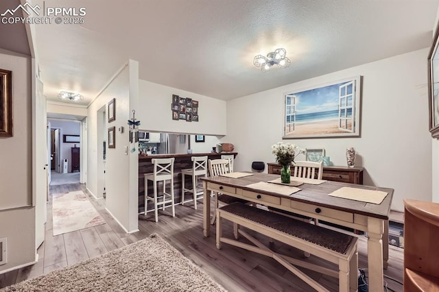 dining space with wood finished floors