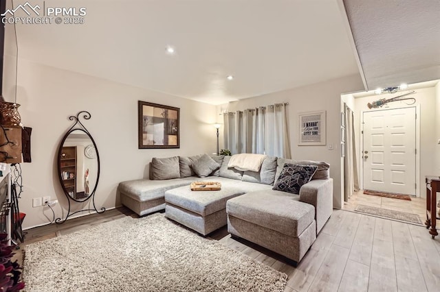 living room with light wood-style flooring and recessed lighting