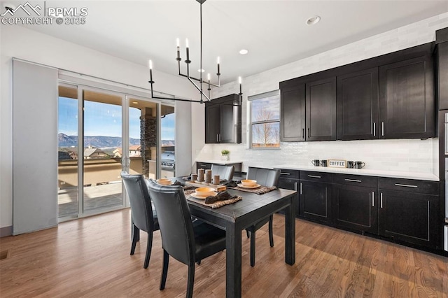 dining space with light wood-style floors, plenty of natural light, and recessed lighting