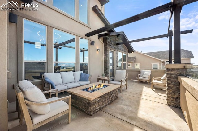 view of patio featuring a lanai and an outdoor living space with a fire pit