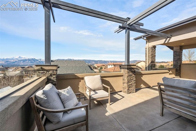 view of patio with a mountain view and a balcony