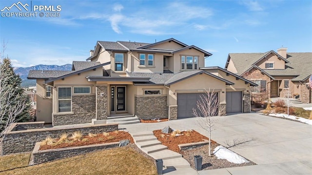 view of front of home featuring driveway, stone siding, a garage, and stucco siding