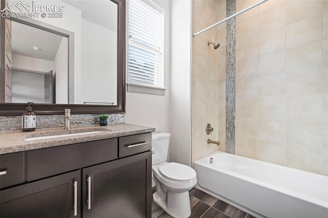 bathroom featuring wood finished floors, vanity, toilet, and shower / bathtub combination