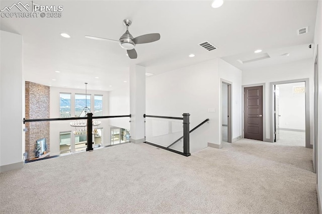 carpeted spare room featuring recessed lighting, visible vents, and baseboards