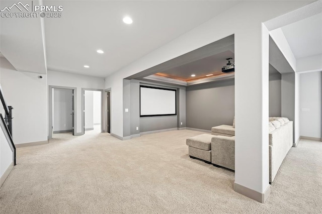 carpeted cinema with recessed lighting, a tray ceiling, and baseboards