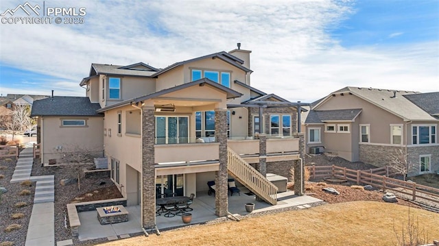 back of property featuring stairway, fence, a patio, and stucco siding