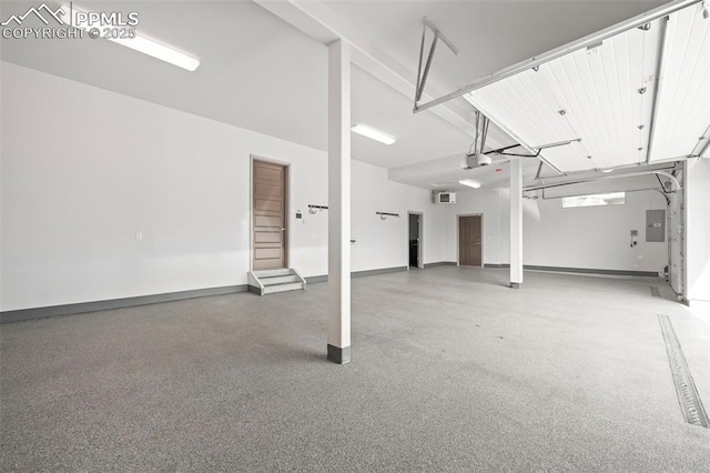 garage featuring a garage door opener, electric panel, and baseboards