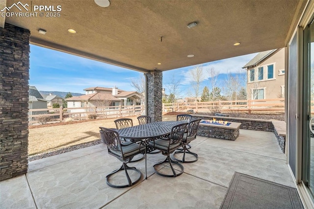 view of patio / terrace featuring an outdoor fire pit, outdoor dining space, and a fenced backyard