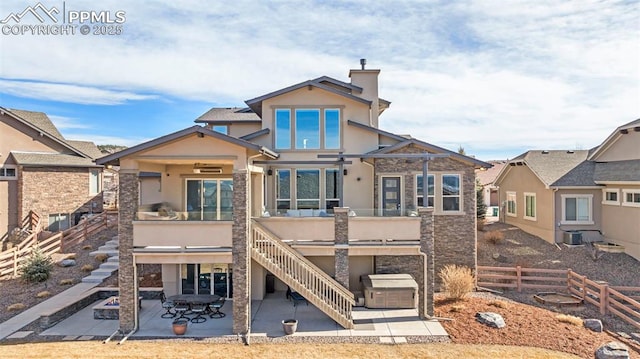 view of front of property with a chimney, stairway, a patio area, and stucco siding