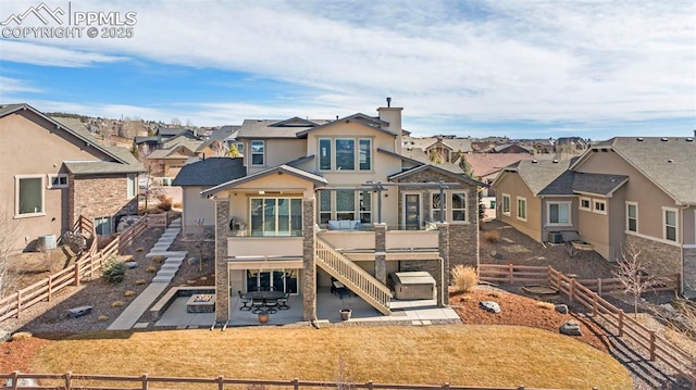 exterior space featuring a residential view, a fenced backyard, a patio, and stucco siding