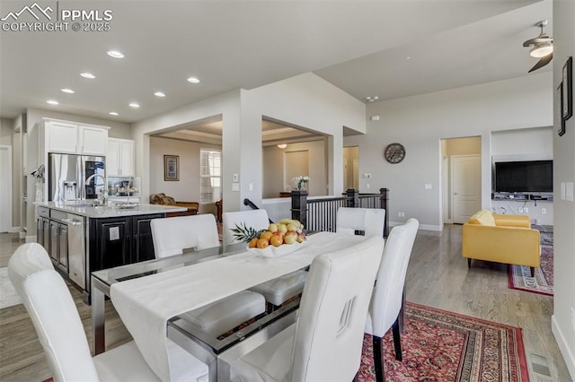 dining space with light wood-type flooring, baseboards, and recessed lighting