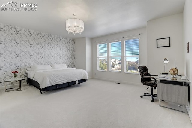 bedroom with wallpapered walls, baseboards, an accent wall, an inviting chandelier, and carpet floors