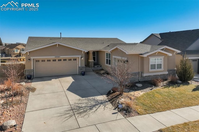 ranch-style home featuring an attached garage, stone siding, and stucco siding