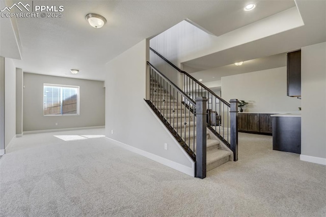 staircase featuring recessed lighting, carpet, and baseboards