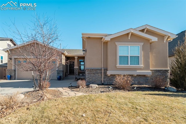 view of front of home featuring driveway, stone siding, stucco siding, an attached garage, and a front yard