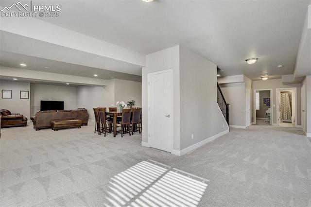 living room featuring baseboards, stairway, recessed lighting, and light colored carpet