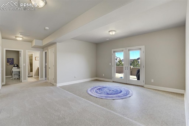 empty room with visible vents, baseboards, and french doors