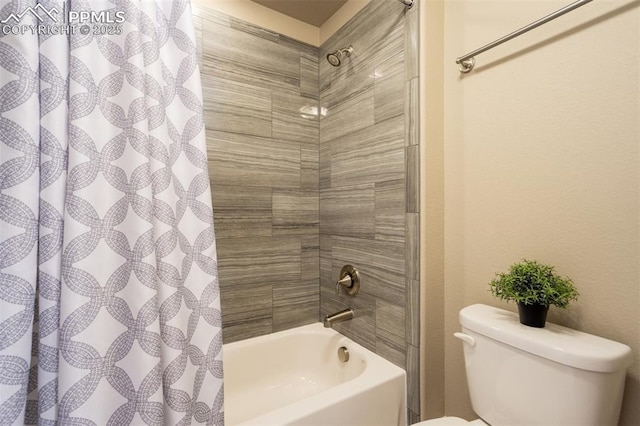 bathroom with shower / bath combination with curtain and toilet