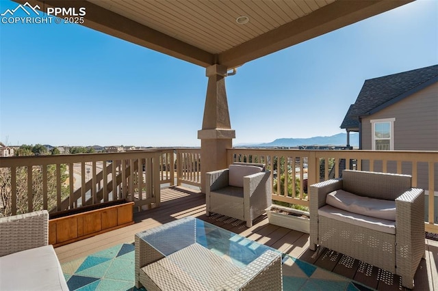 wooden terrace with outdoor lounge area and a mountain view