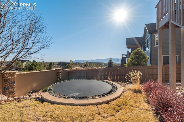 view of yard with fence and a mountain view