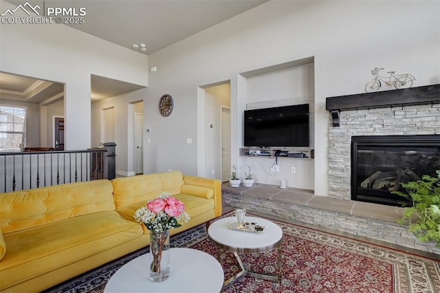 living room with a stone fireplace