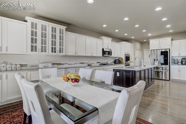 dining room featuring light wood finished floors and recessed lighting