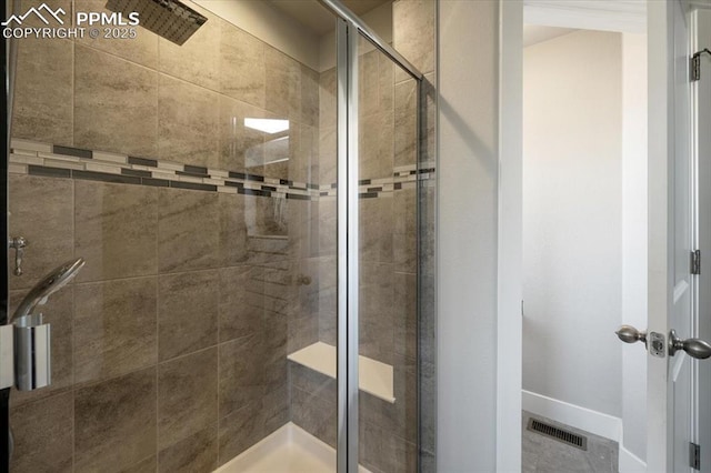 full bathroom with a shower stall, visible vents, and baseboards