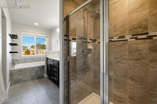 full bath featuring a bath, a stall shower, tile patterned flooring, and vanity