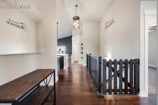 hall with baseboards and wood finished floors