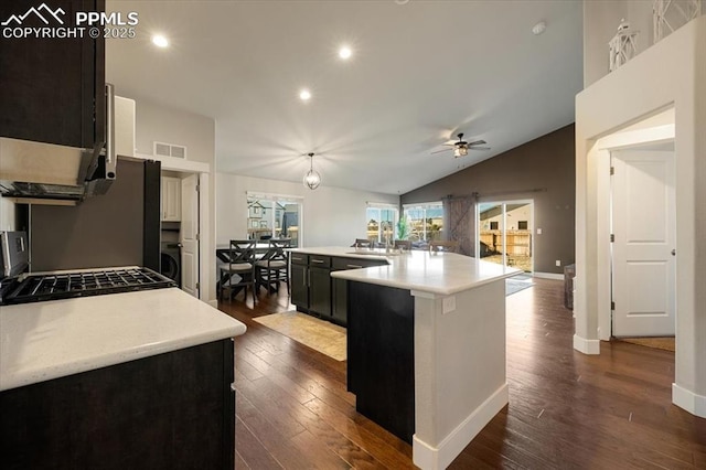 kitchen with visible vents, lofted ceiling, dark wood-style floors, open floor plan, and light countertops