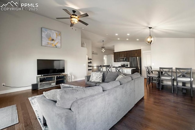 living area with lofted ceiling, recessed lighting, dark wood-style flooring, a ceiling fan, and baseboards