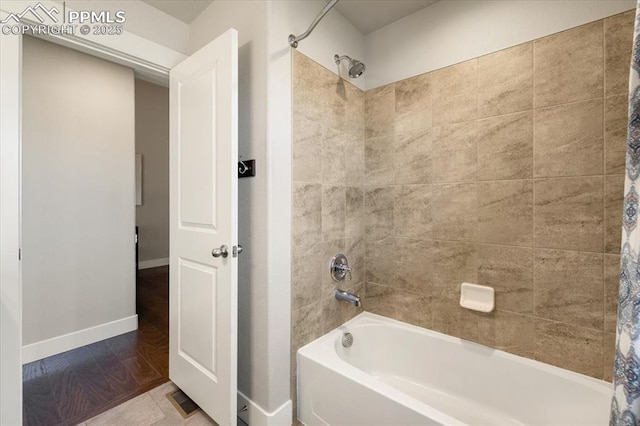 full bath featuring baseboards and shower / bath combination with curtain