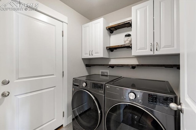 clothes washing area with cabinet space and independent washer and dryer