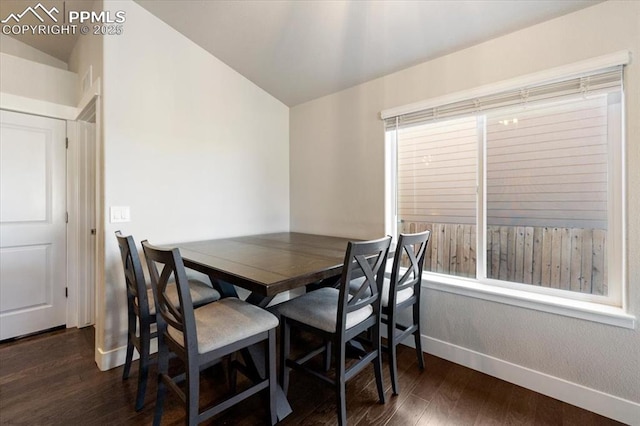 dining area with vaulted ceiling, dark wood finished floors, and baseboards