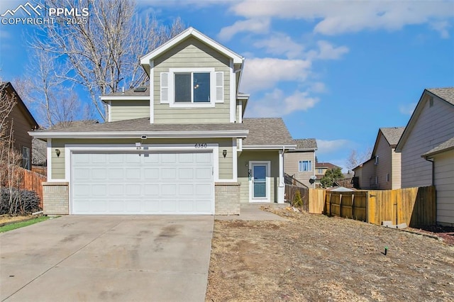 view of front of house with driveway, fence, and brick siding