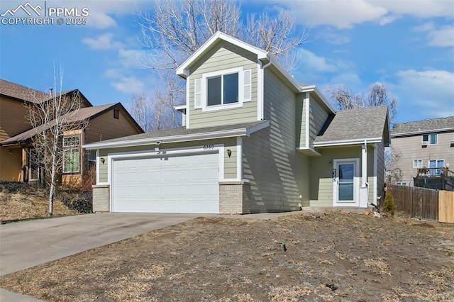 traditional-style house featuring brick siding, driveway, and fence