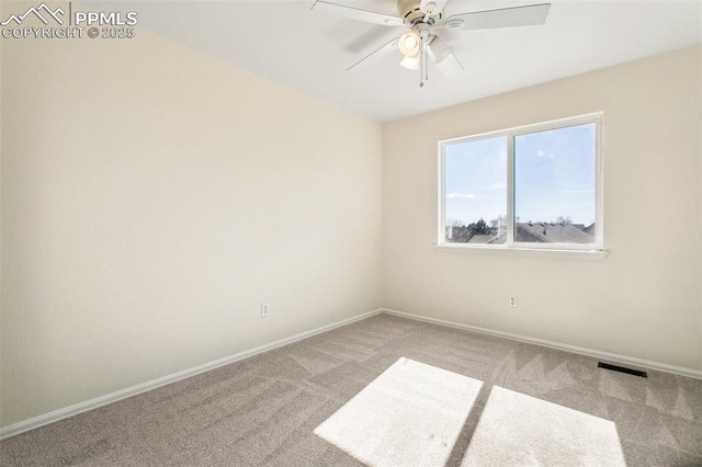 unfurnished room with light colored carpet, ceiling fan, visible vents, and baseboards