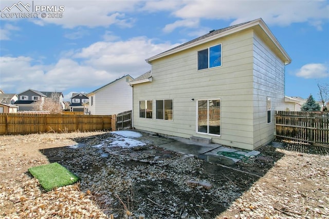 back of property featuring a residential view, a patio area, and a fenced backyard