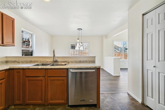 kitchen featuring hanging light fixtures, a sink, light countertops, and dishwasher