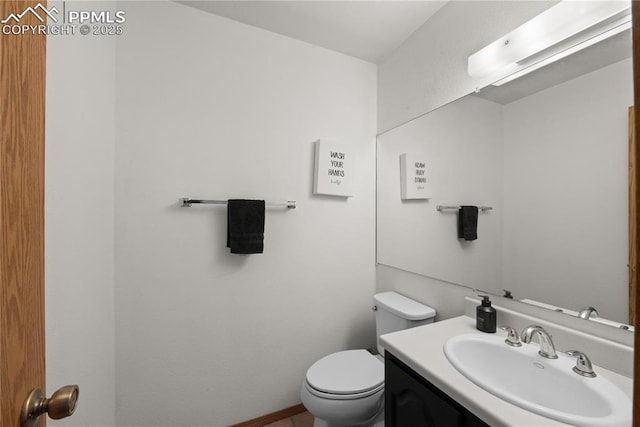 half bath featuring toilet and vanity