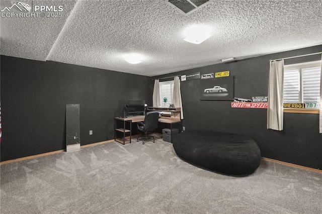 carpeted office featuring baseboards, visible vents, and a textured ceiling