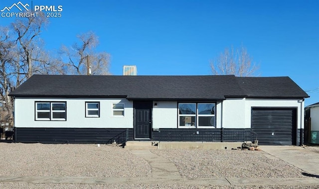 ranch-style house with a garage and driveway