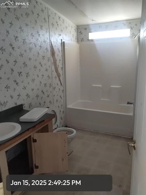 full bathroom with toilet, wallpapered walls, shower / tub combination, and vanity