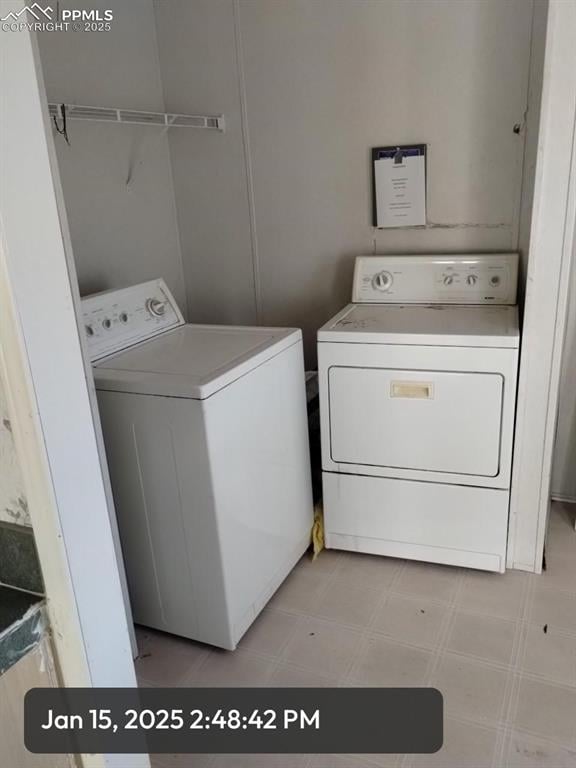 laundry room with light floors, laundry area, and separate washer and dryer