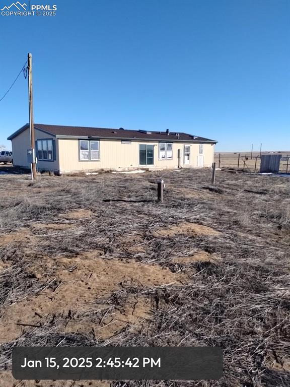 back of house with fence